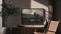 Windswept trees by a pond print in a wood frame above a fluted sideboard beside an olive tree