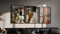 Roses, Wine and Candlelit Bath Set of 3 in black frames on a grey wall above a leather sofa
