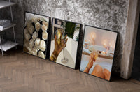 Roses, Wine and Candlelit Bath Set of 3 as black-framed prints leaning against a raw-plaster wall