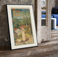 Woman serving glass of water print in a black frame leaning beside a vintage door on parquet