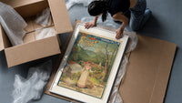 Woman serving glass of water framed print being unpacked from protective bubble wrap and a box