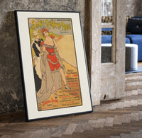 Woman in red bathing suit at beach print in a black frame leaning beside a vintage door on parquet