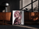 Black-framed Pink-haired anime kunoichi girl print on a moody console with designer coffee-table books