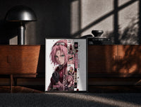 Black-framed Pink-haired anime kunoichi girl print on a moody console with designer coffee-table books