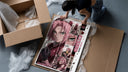 Pink-haired anime kunoichi girl framed print being unpacked from protective bubble wrap and a box