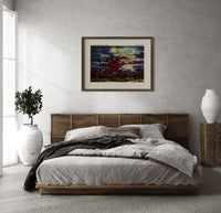 Witch flying on broomstick with cat print in a dark wood frame above a rattan bed on a plaster wall