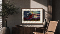 Witch flying on broomstick with cat print in a wood frame above a fluted sideboard beside an olive tree