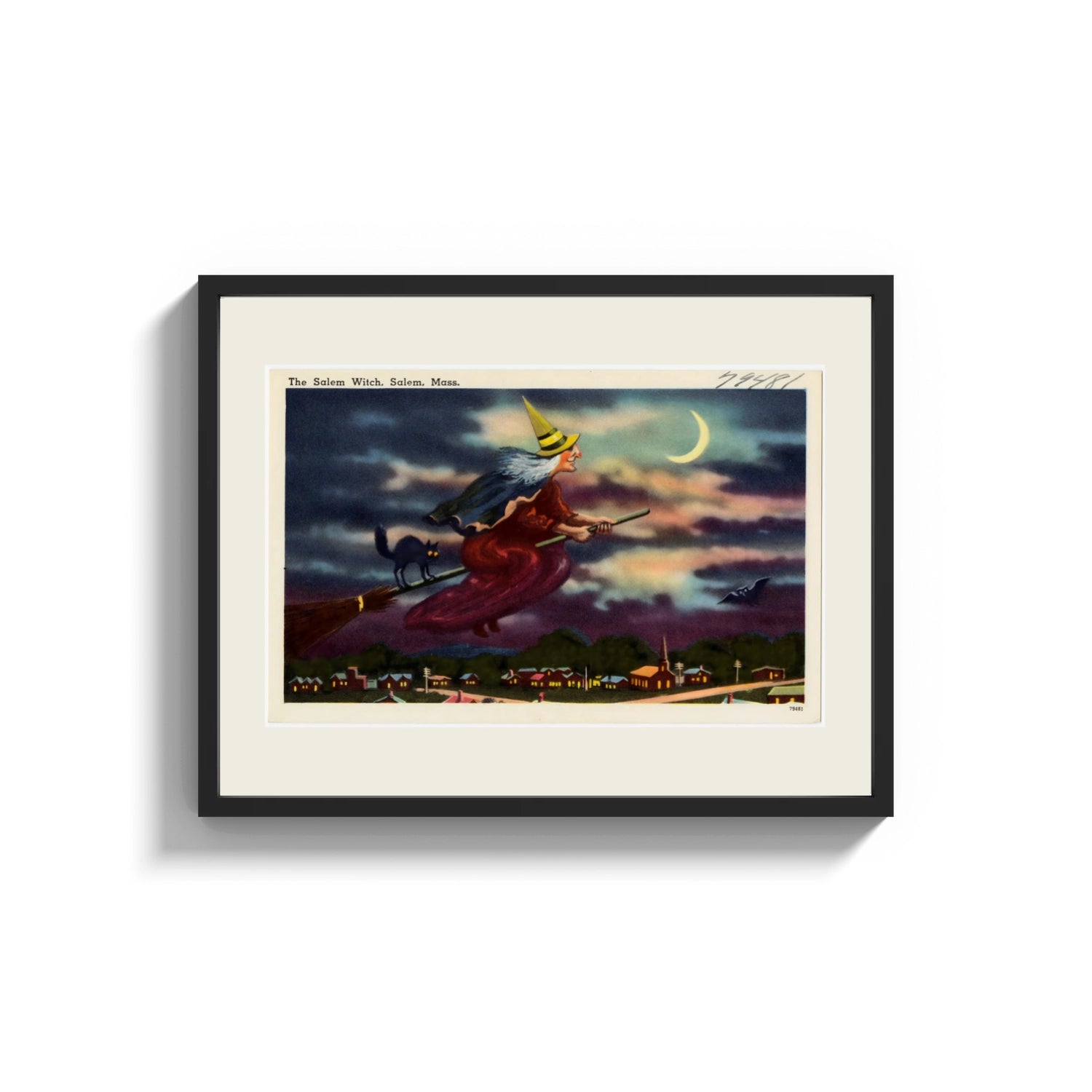 Framed Witch flying on broomstick with cat print shown as a wide statement piece on a clean white wall