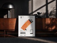 Black-framed Salmon Lighter Seafood Market print on the floor in front of a dark wooden console