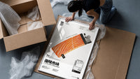 Salmon Lighter Seafood Market framed print being unpacked from protective bubble wrap and a box