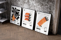 Salmon Sushi Lighter Set of 3 set of three black-framed prints leaning against a raw-plaster wall
