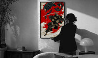 Oni-masked samurai leaping with drawn katana print in a slim black frame being hung on a sunlit wall in a monochrome room