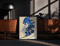 Black-framed Samurai swordsman with blue lightning dragon print on a moody console with designer coffee-table books
