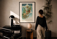 Santa A Merry Christmas print in a black frame on a sunlit plaster wall, a person looking on beside a mushroom lamp