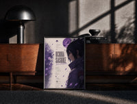 Black-framed Anime male character profile portrait print on a moody console with designer coffee-table books