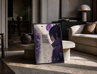 Anime male character profile portrait print in a black frame leaning on a travertine table in a sunlit lounge
