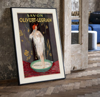 Woman bathing in soap suds print in a black frame leaning beside a vintage door on parquet