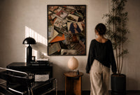 Scattered CD Album Cases print in a black frame on a sunlit plaster wall, a woman looking on beside a mushroom lamp