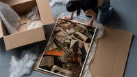 Scattered CD Album Cases framed print being unpacked from protective bubble wrap and a box
