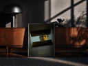 Black-framed Se7en box scene print on a moody console with designer coffee-table books
