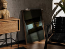Walnut-framed Se7en box scene print leaning against a sunlit rustic brick wall