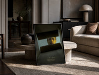 Se7en box scene print in a black frame leaning on a travertine table in a sunlit lounge