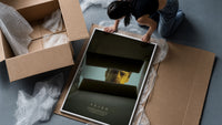Se7en box scene framed print being unpacked from protective bubble wrap and a box