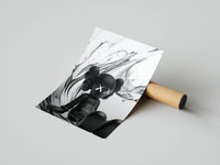 Seated KAWS companion on silver fluid paint splash monochrome rolled print beside a cardboard shipping tube
