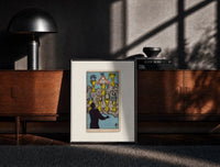 Black-framed Seven Cups of Wands tarot card print on a moody console with designer coffee-table books