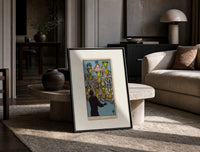 Seven Cups of Wands tarot card print in a black frame leaning on a travertine table in a sunlit lounge