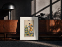 Black-framed Man leaning on staff with pentacles print on a moody console with designer coffee-table books
