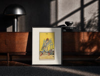 Black-framed Man carrying five swords print on a moody console with designer coffee-table books