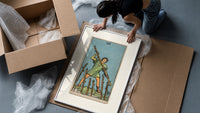 Man holding staff among wands framed print being unpacked from protective bubble wrap and a box