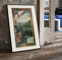 Landscape view of Paris from hills print in a black frame leaning beside a vintage door on parquet
