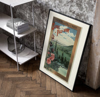 Landscape view of Paris from hills poster in a black frame leaning beside a shelf in a raw-plaster loft