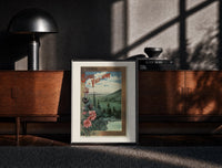 Black-framed landscape view of Paris from hills print on a moody console with designer coffee-table books