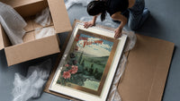 Landscape view of Paris from hills framed print being unpacked from protective bubble wrap and a box