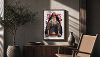 Red-haired man sitting on block poster framed above a fluted sideboard beside an olive tree