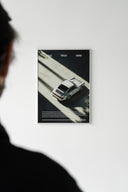 Silver Porsche 911 in moody shadow and light composition poster displayed with a tube