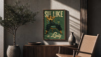 Sit Like a Lady poster framed above a fluted sideboard beside a potted tree