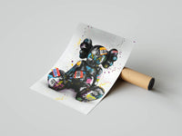 Sitting KAWS Companion covered in multicolor graffiti tags and stickers, unrolled from a cardboard tube on a gray surface