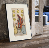 Merchant giving coins to beggars print in a black frame leaning beside a vintage door on parquet