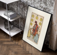 Merchant giving coins to beggars poster in a black frame leaning beside a shelf in a raw-plaster loft