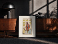 Black-framed Merchant giving coins to beggars print on a moody console with designer coffee-table books