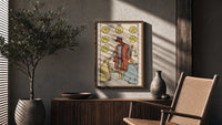 Six of Pentacles poster framed above a fluted sideboard beside a potted tree
