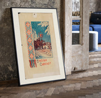 Christmas carollers with star in snowy village print in a black frame leaning beside a vintage door on parquet