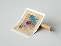 Rolled Christmas carollers with star in snowy village poster beside its crush-resistant kraft shipping tube