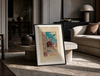Christmas carollers with star in snowy village print in a black frame leaning on a travertine table in a sunlit lounge
