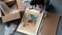 Christmas carollers with star in snowy village framed print being unpacked from protective bubble wrap and a box