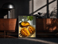 Black-framed Sliced Mango print on the floor in front of a dark wooden console